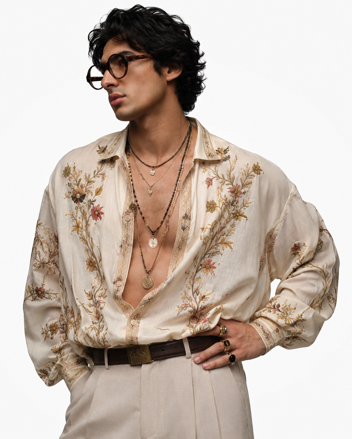 Man in an open floral shirt layered with gold necklaces