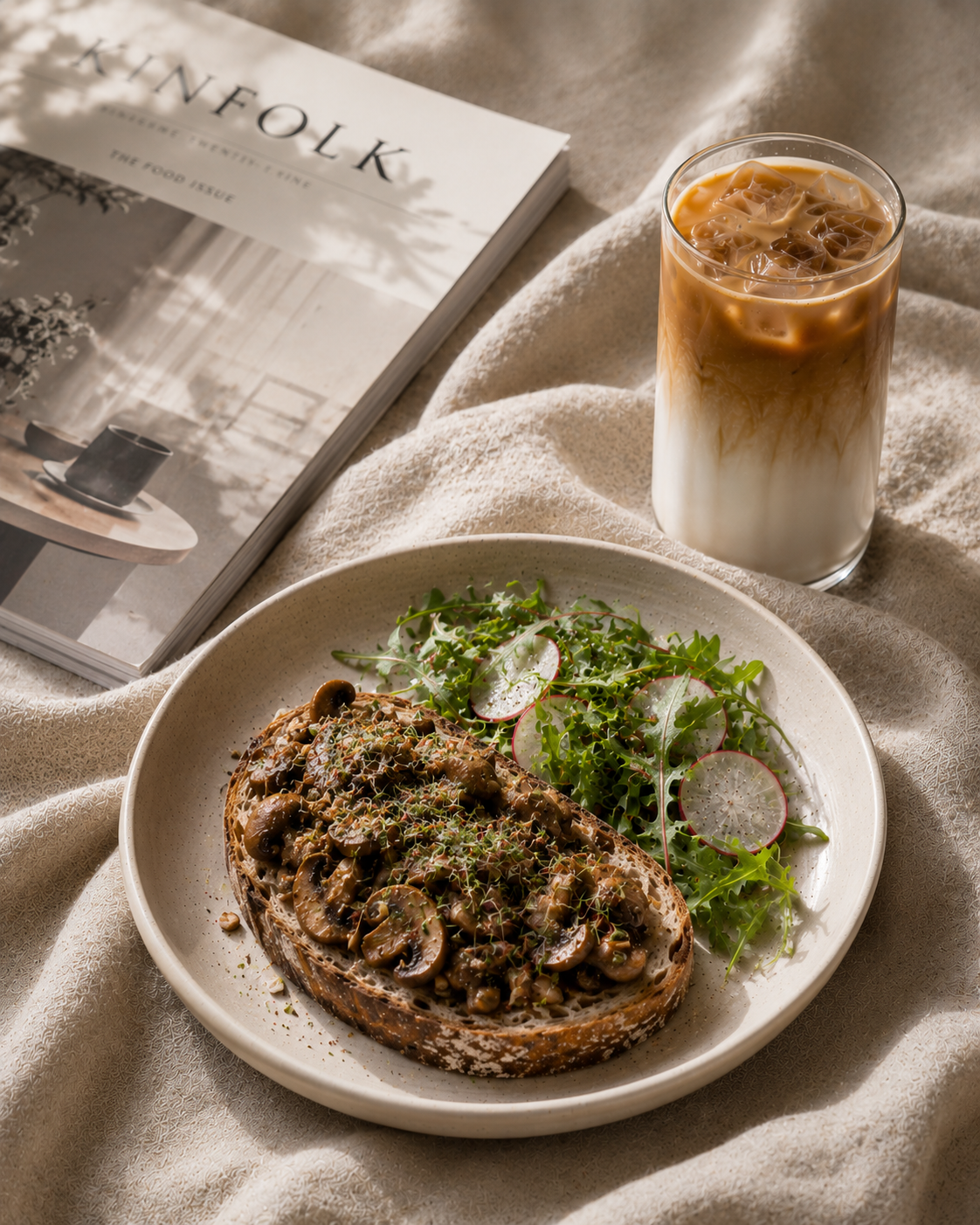 Mushroom toast with iced latte and magazine