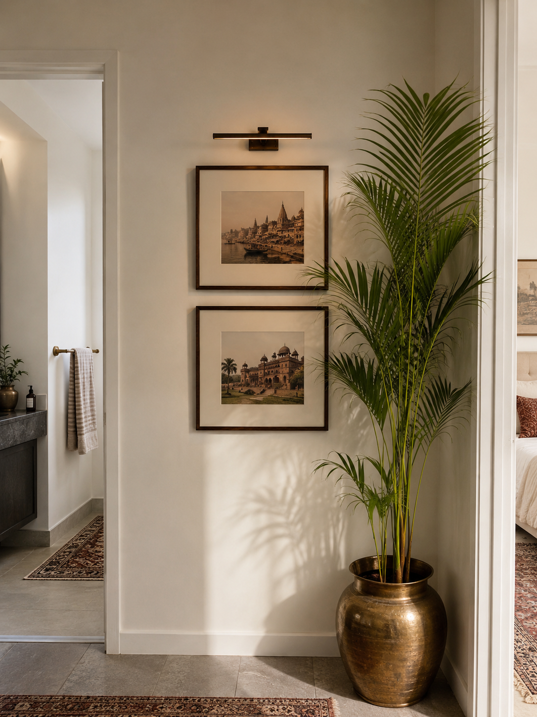 Framed Company School prints and a brass urn palm in a hallway